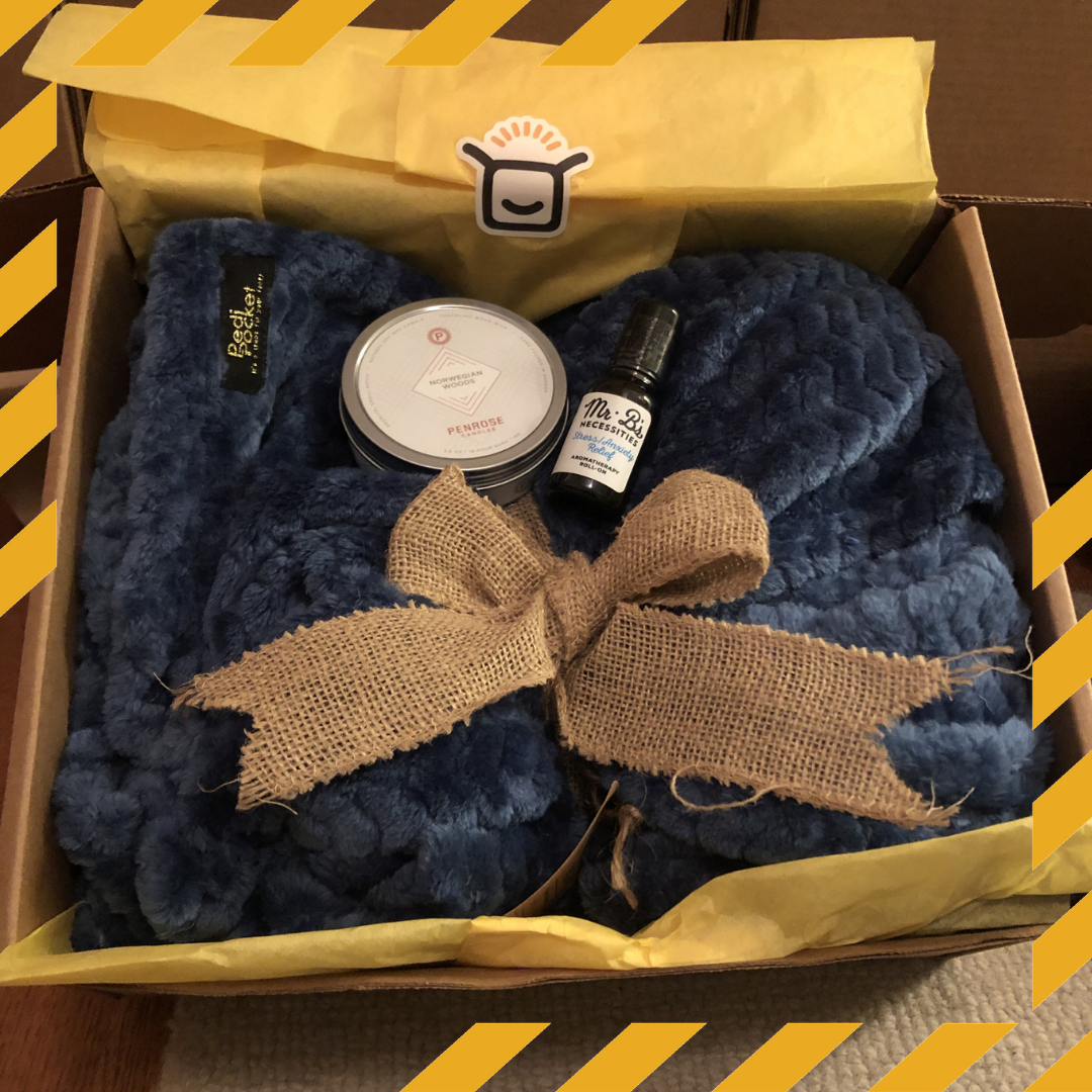 Hygge care package with blanket, candle and essential oils