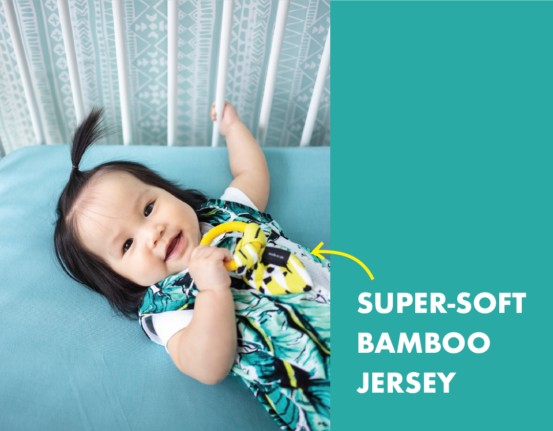 super soft bamboo jersey - showing image of little girl in palm print sleep sack with teether in hand