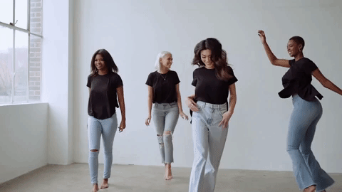 Women dancing against a white background