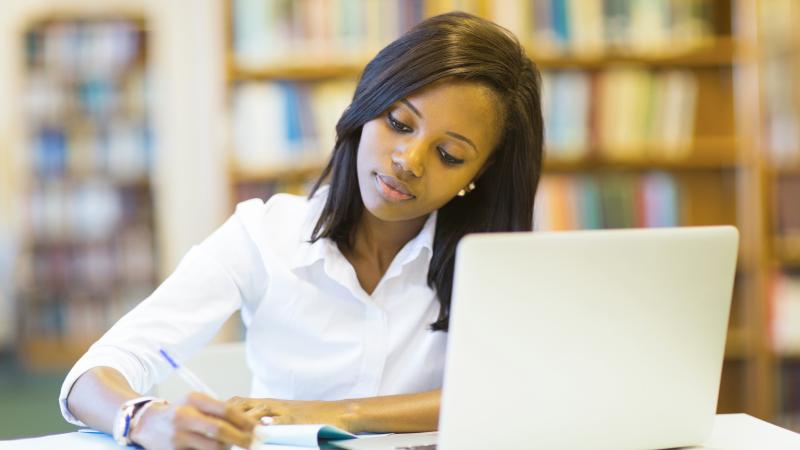 pretty_female_college_student_studying_in_library.jpg Thumbnail