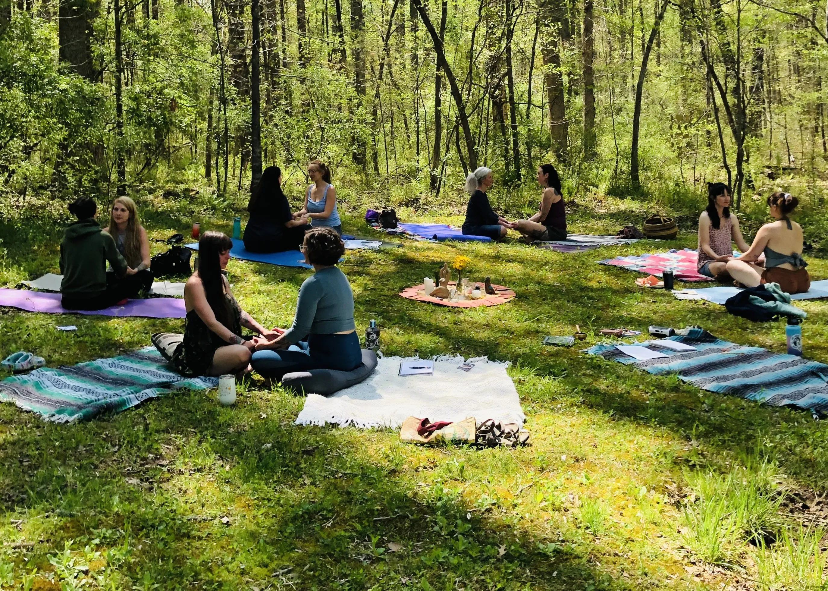 Women sitting in circle in forest