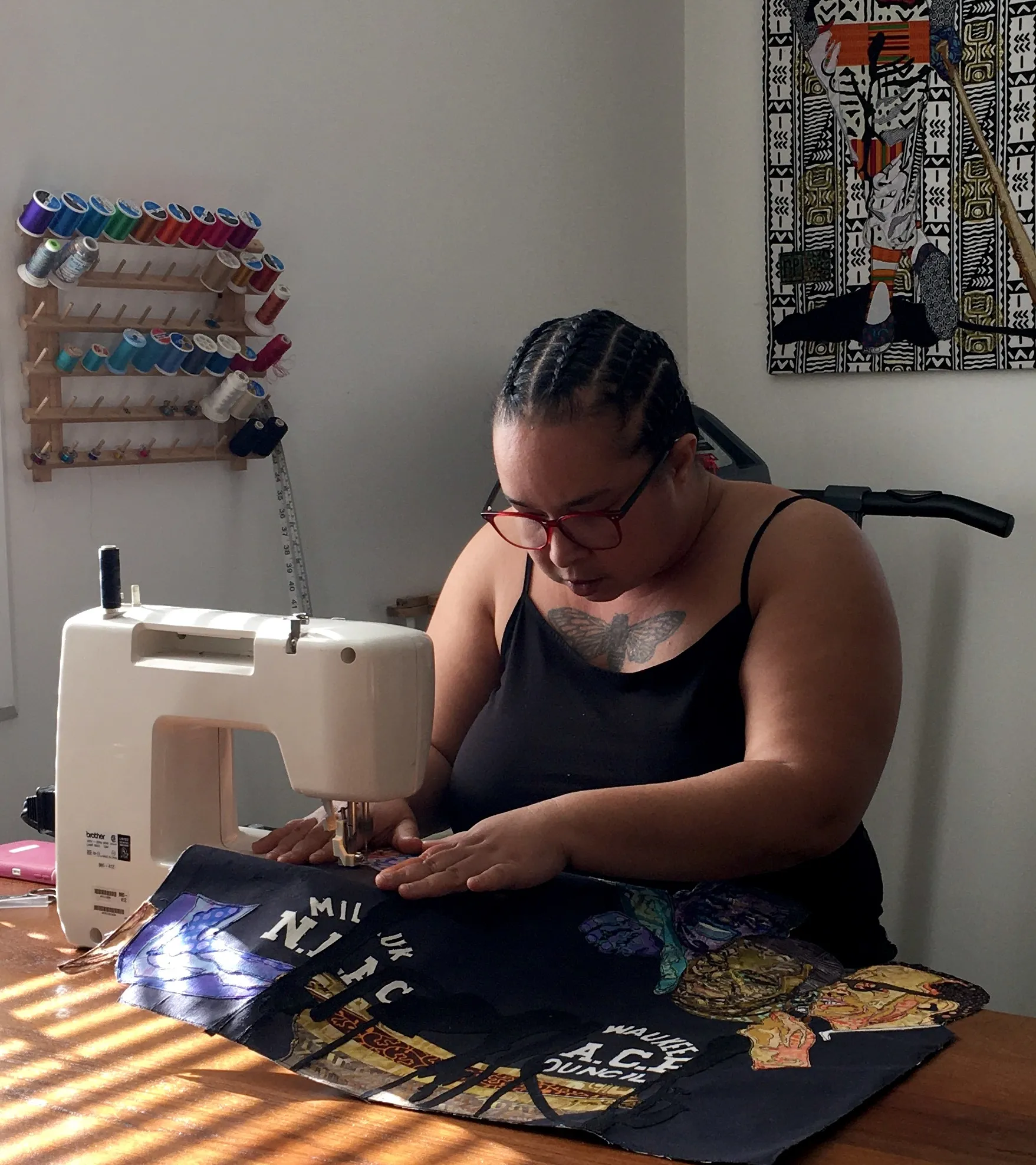 rosy petri in the studio working at her sewing machine. 
