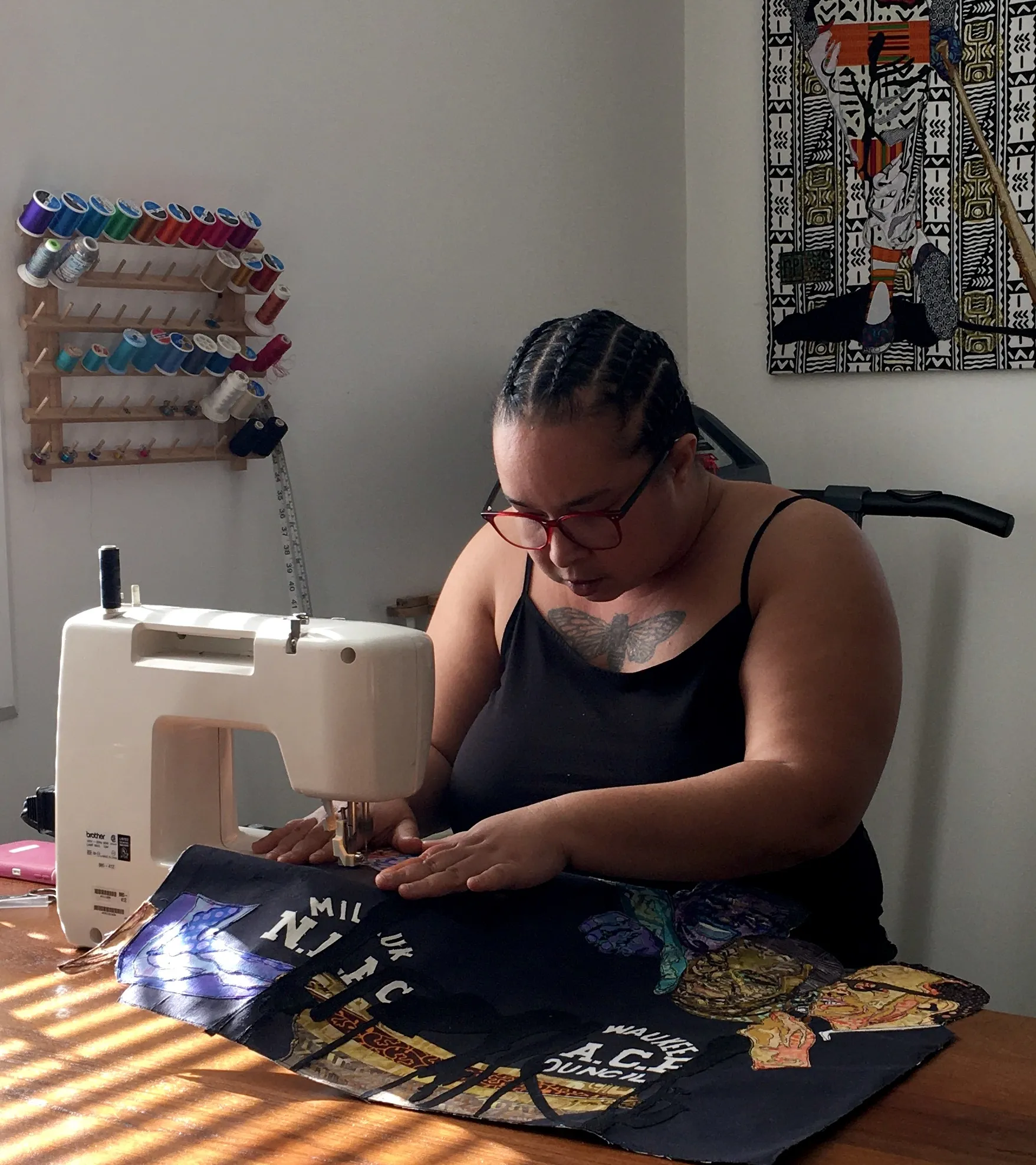rosy petri in the studio working at her sewing machine.
